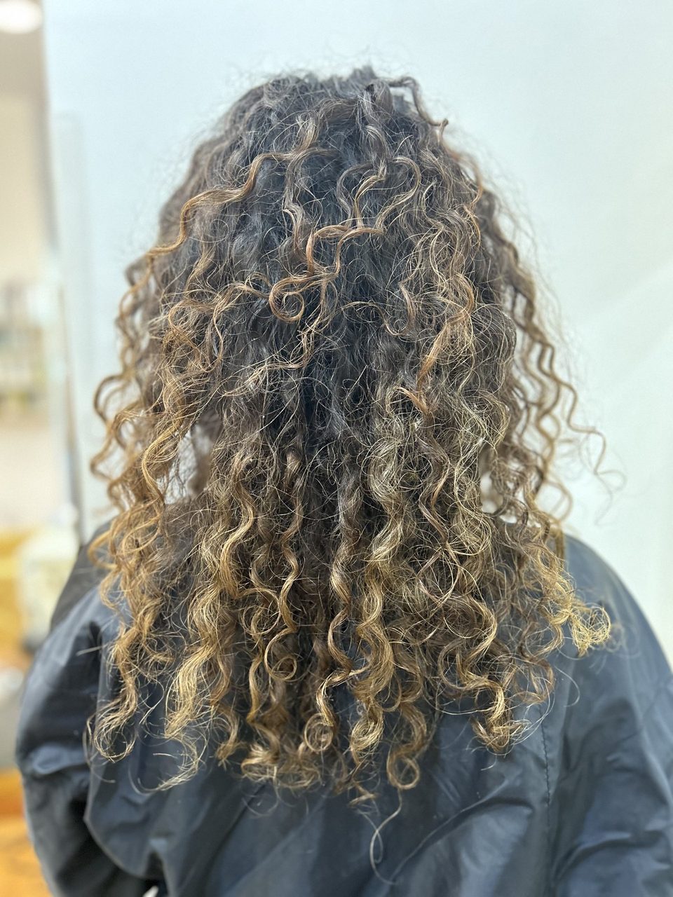 Before: grown-out, undefined curls with faded highlights