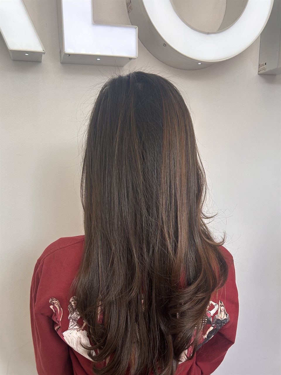 Long smooth dark brown hair with subtle highlights in the Frenzy Salon studio